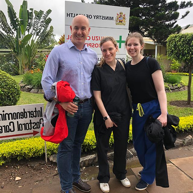 Eric McCollum with physicians Brittany Hunter, left, and Chiara Bertolaso at Kamuzu Central Hospital